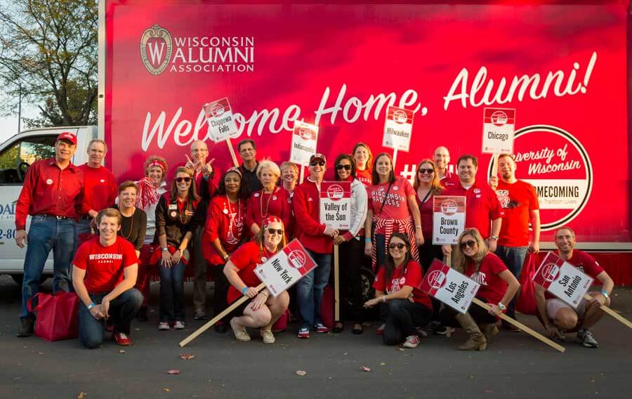 Alumni volunteers have a long-standing tradition of walking together in the Homecoming parade, representing all the areas of the country that are populated with UW grads.