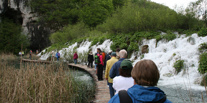 A group of travelers observing a waterfall