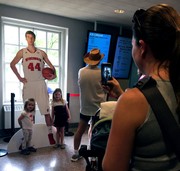Cut-out of Frank Kaminsky poses with young fans.