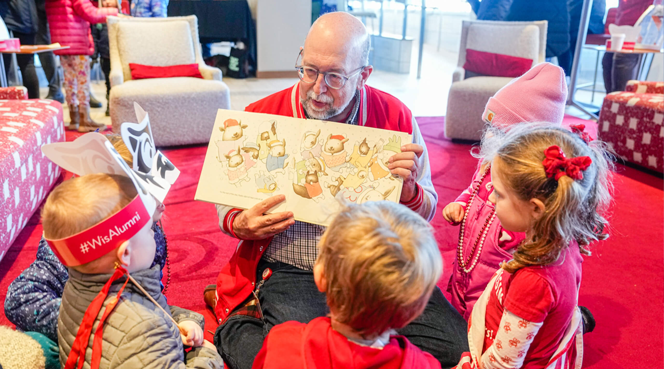 Someone reading books to kids in One Alumni Place