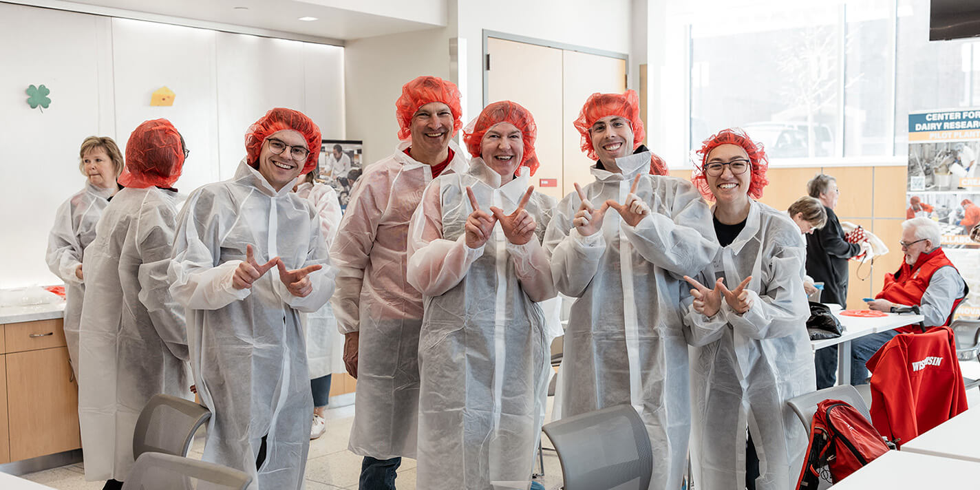 University of Wisconsin students dressed in protective coveralls and hairnets as they work on dairy research and innovation during our event Made at the UW: Dairy