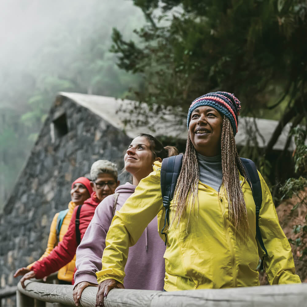 Alumni enjoying a hike in a green forest