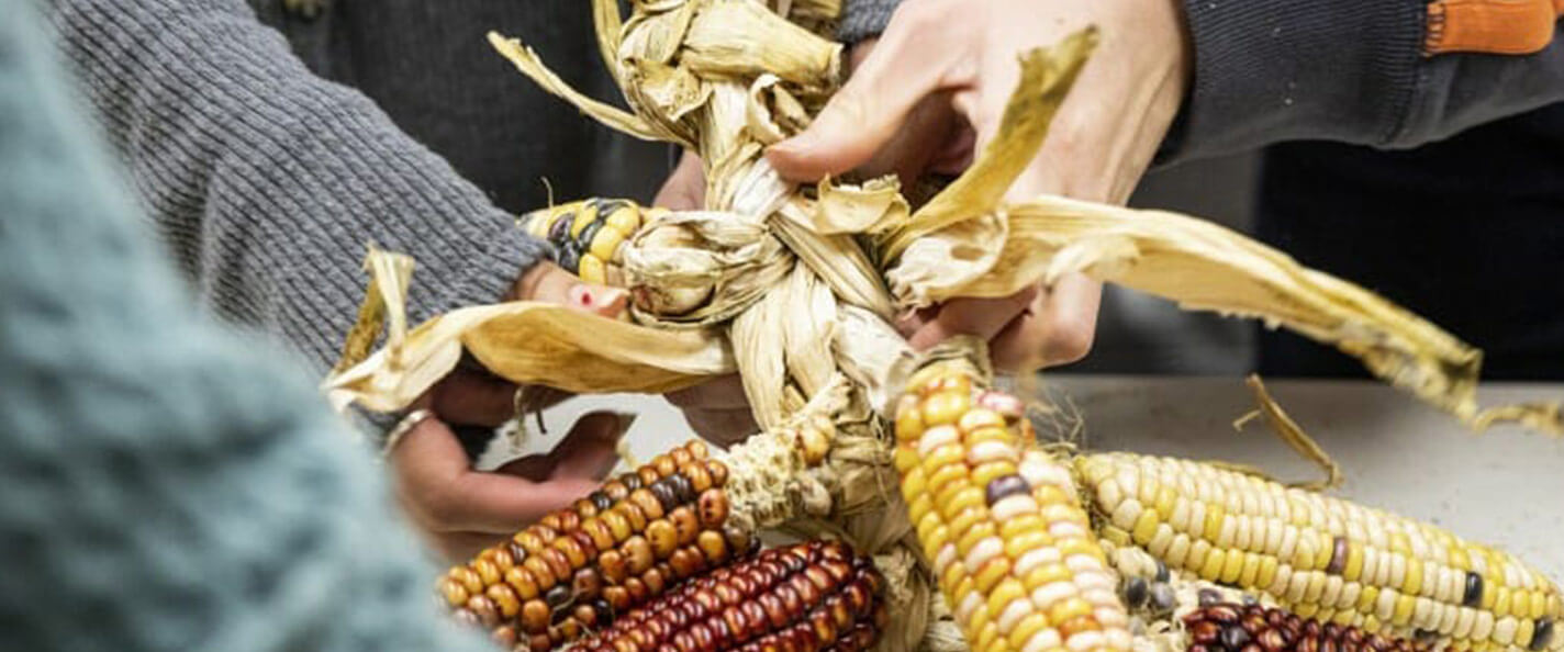 Students braid corn husks.