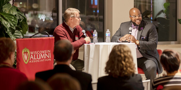 Two speakers address the audience at an enrichment event.