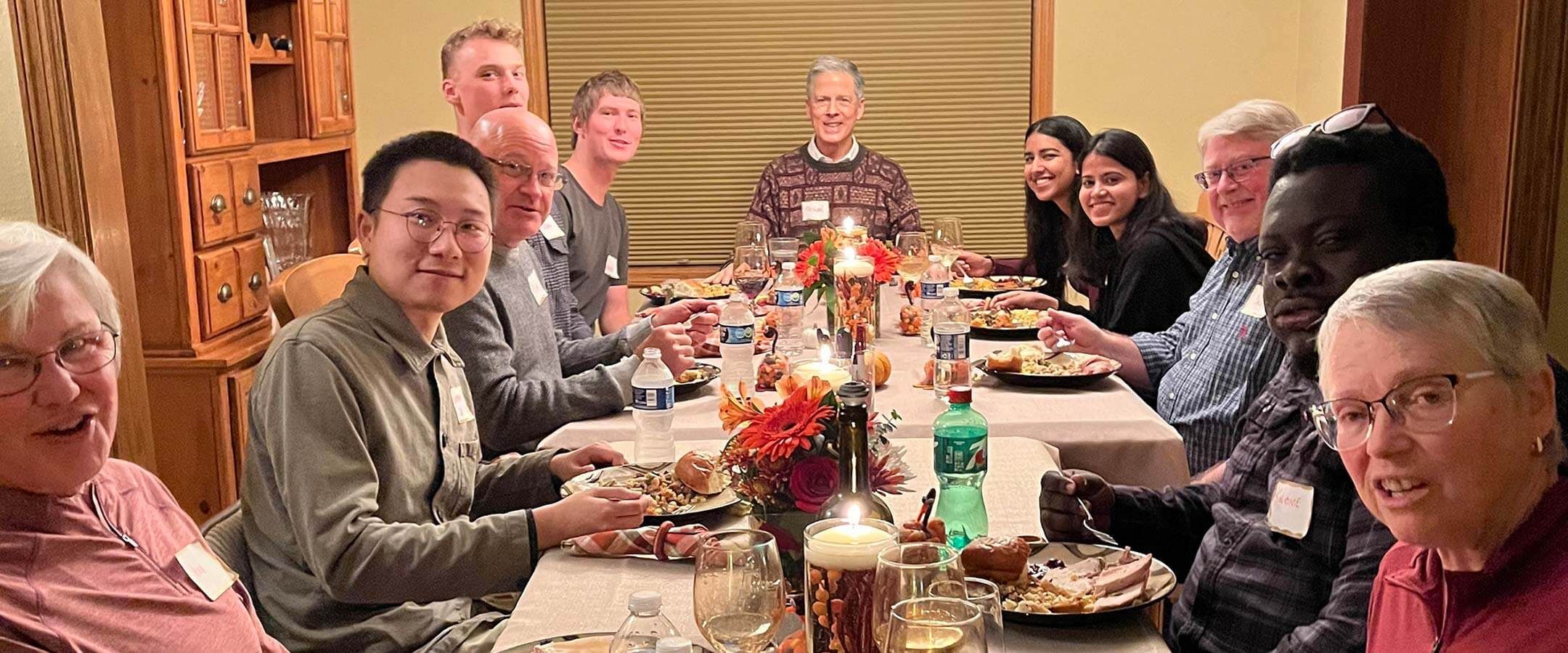 A group of people sitting around a dinner table.