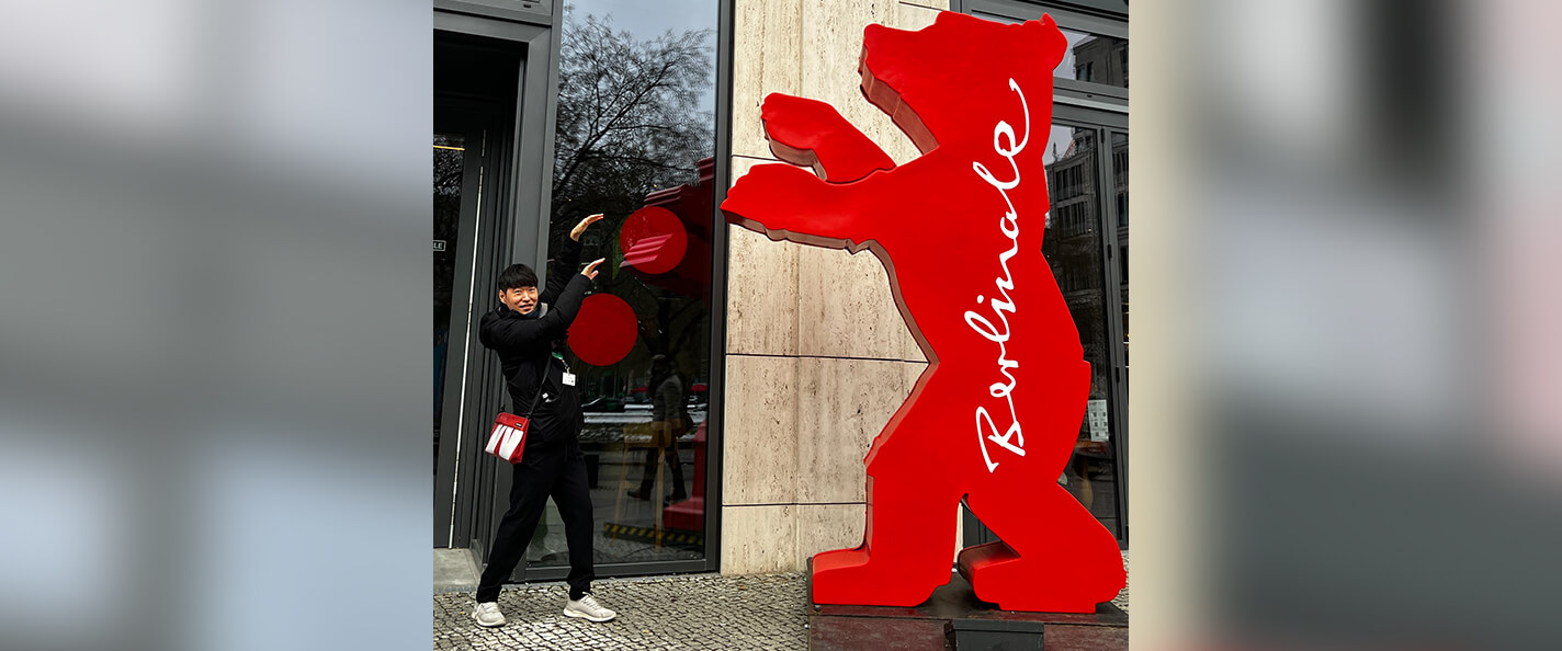 Kim poses with a sign for the Berlinale Film Festival.