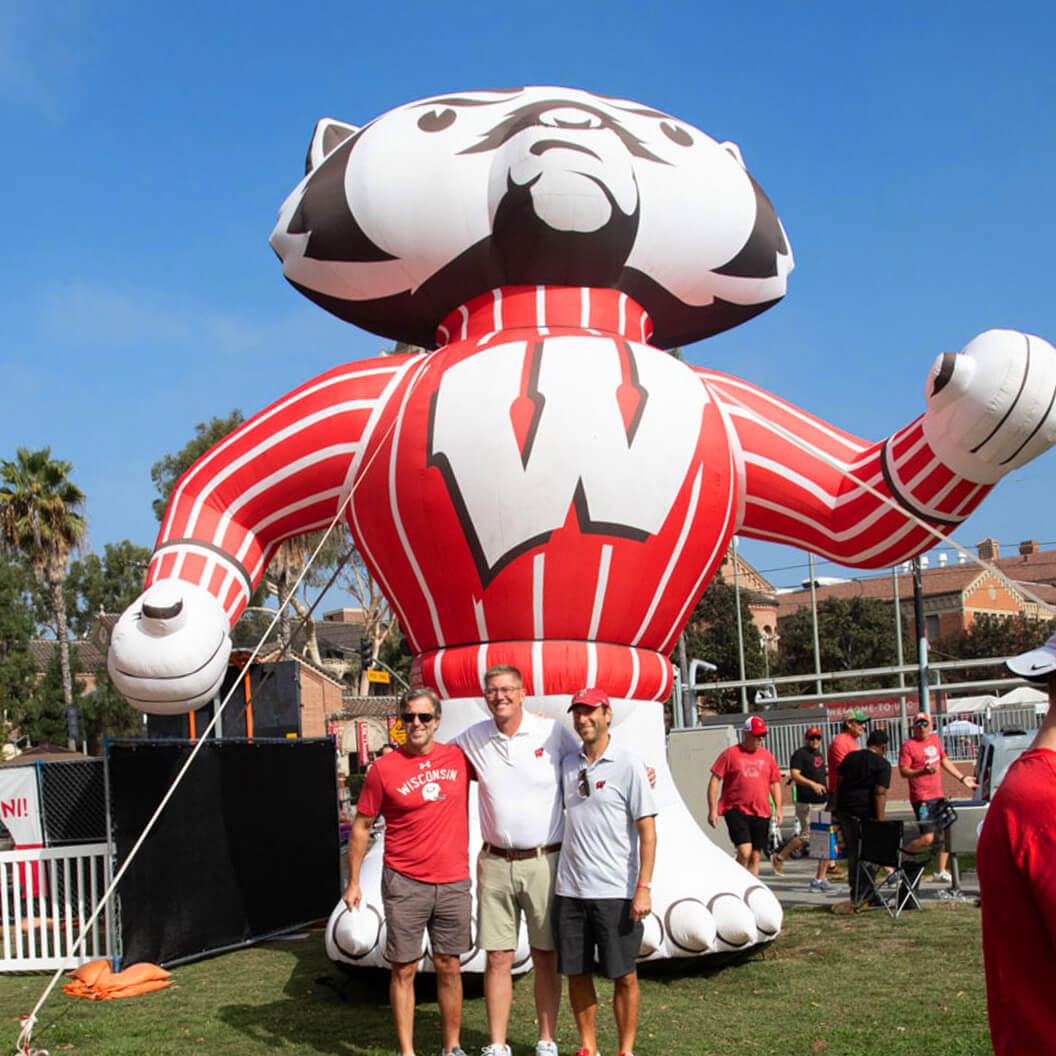 Fans pose with an inflatable Bucky