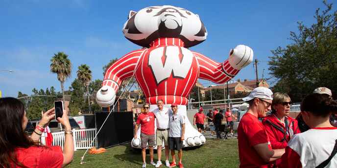 Fans pose with an inflatable Bucky