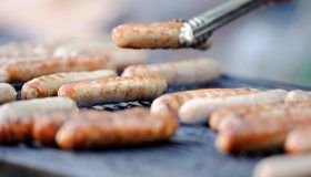 Brats being cooked on a grill