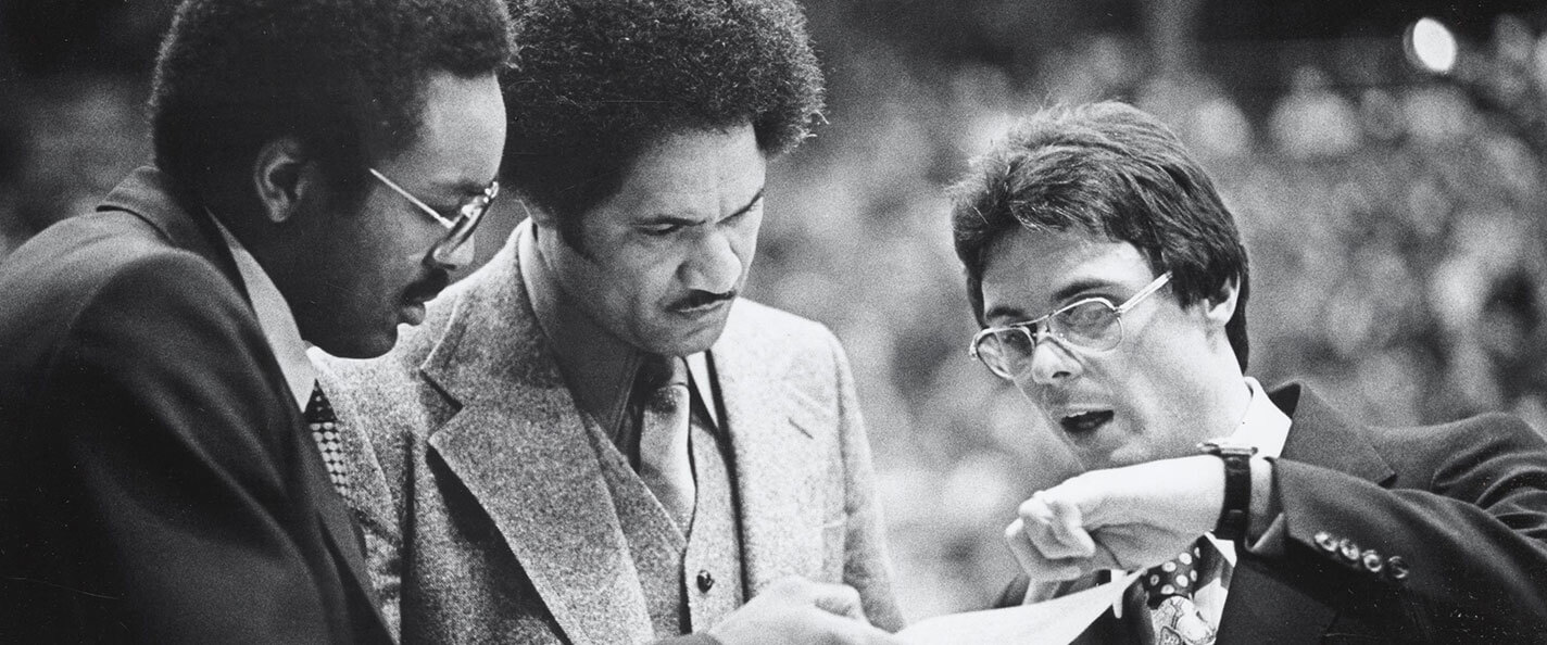 Bill Cofield discusses with his assistant coaching staff.