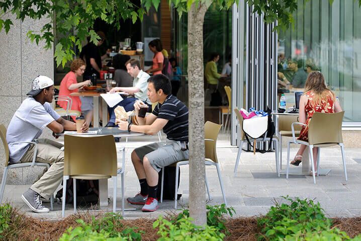 WITH THE PATIO DOORS TO ALDO'S CAFE WIDE OPEN, PEOPLE ENJOY TAKING A BREAK TO EAT AND SOCIALIZE OUTSIDE THE WISCONSIN INSTITUTES FOR DISCOVERY ON JUNE 11, 2013. (PHOTO BY JEFF MILLER / UNIVERSITY COMMUNICATIONS)
